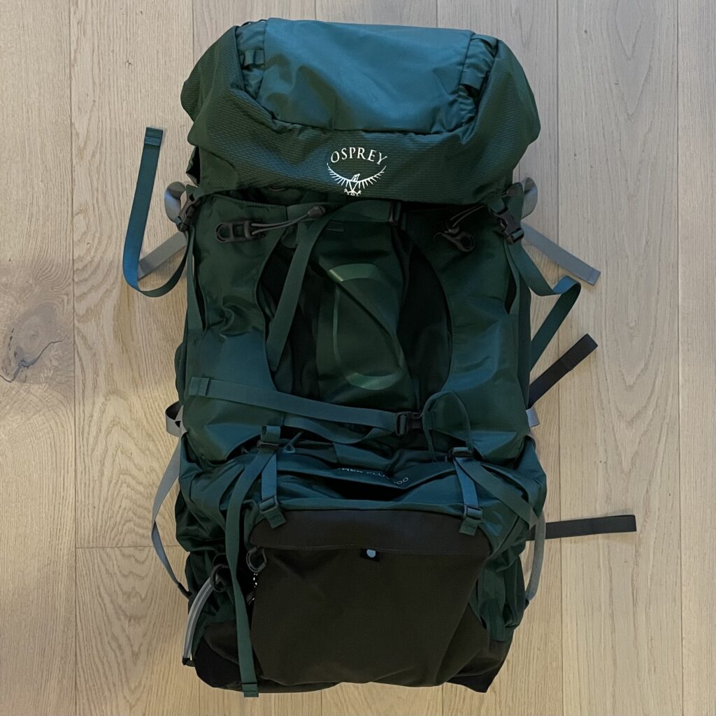 An Osprey technical backpack, 100 litres, on a floor.