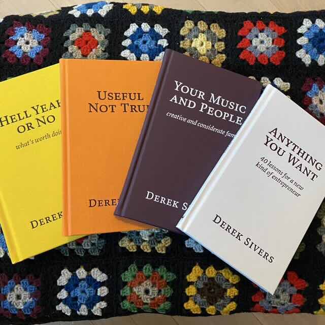 Photo of four bound books in various colours