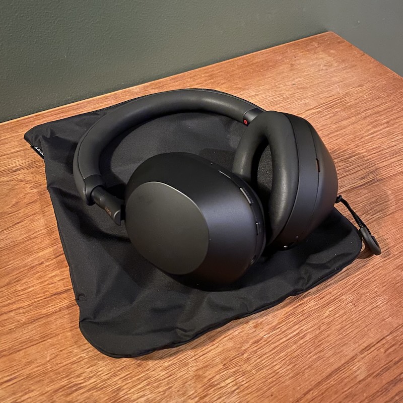 A black pair of Sony WH-1000MX5 lying on a cupboard